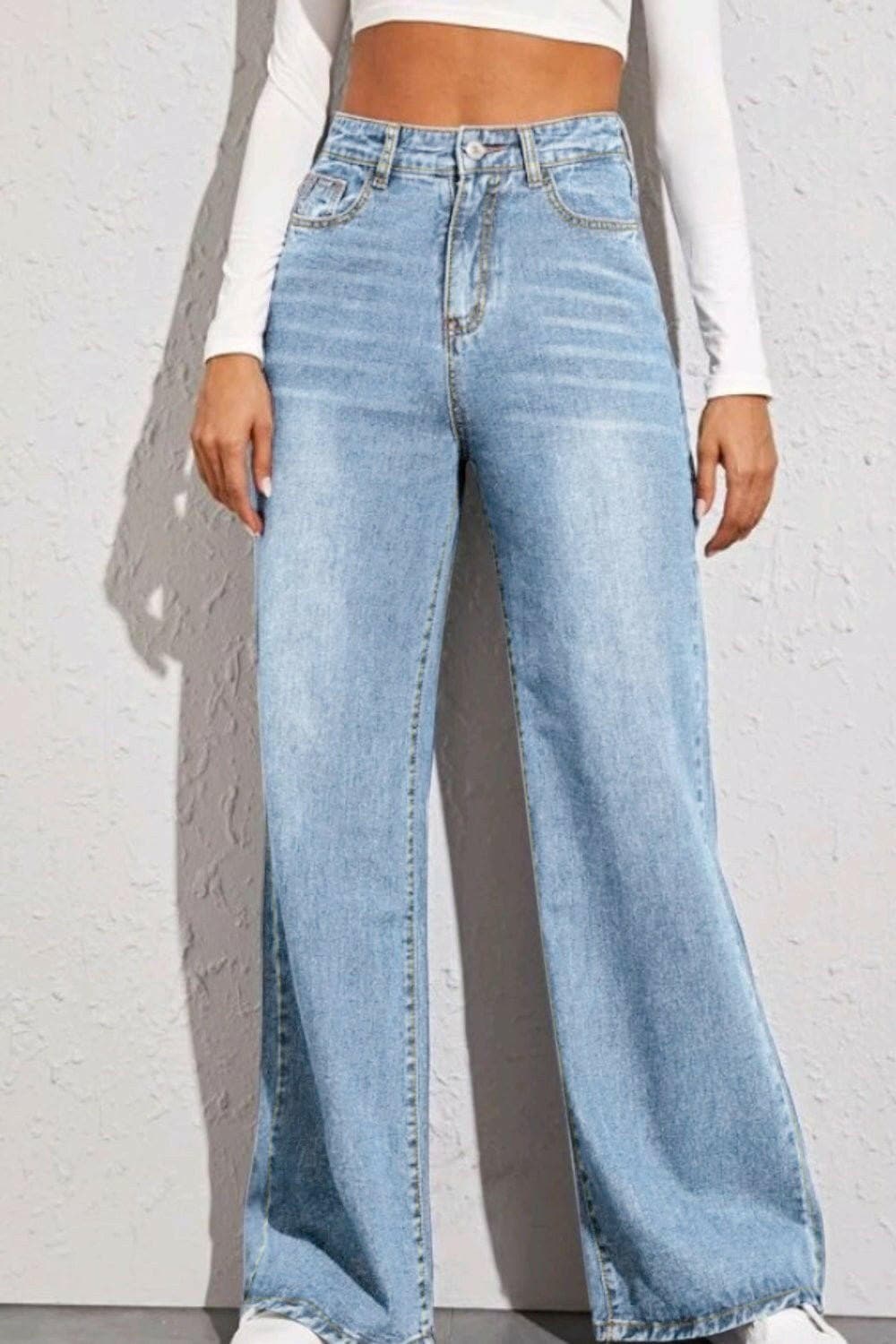 Wide leg high-rise denim trousers showcasing front view on person.