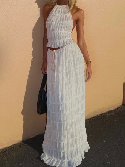 Backless lace-up halter top set and two-piece chiffon pleated long skirt with earrings.