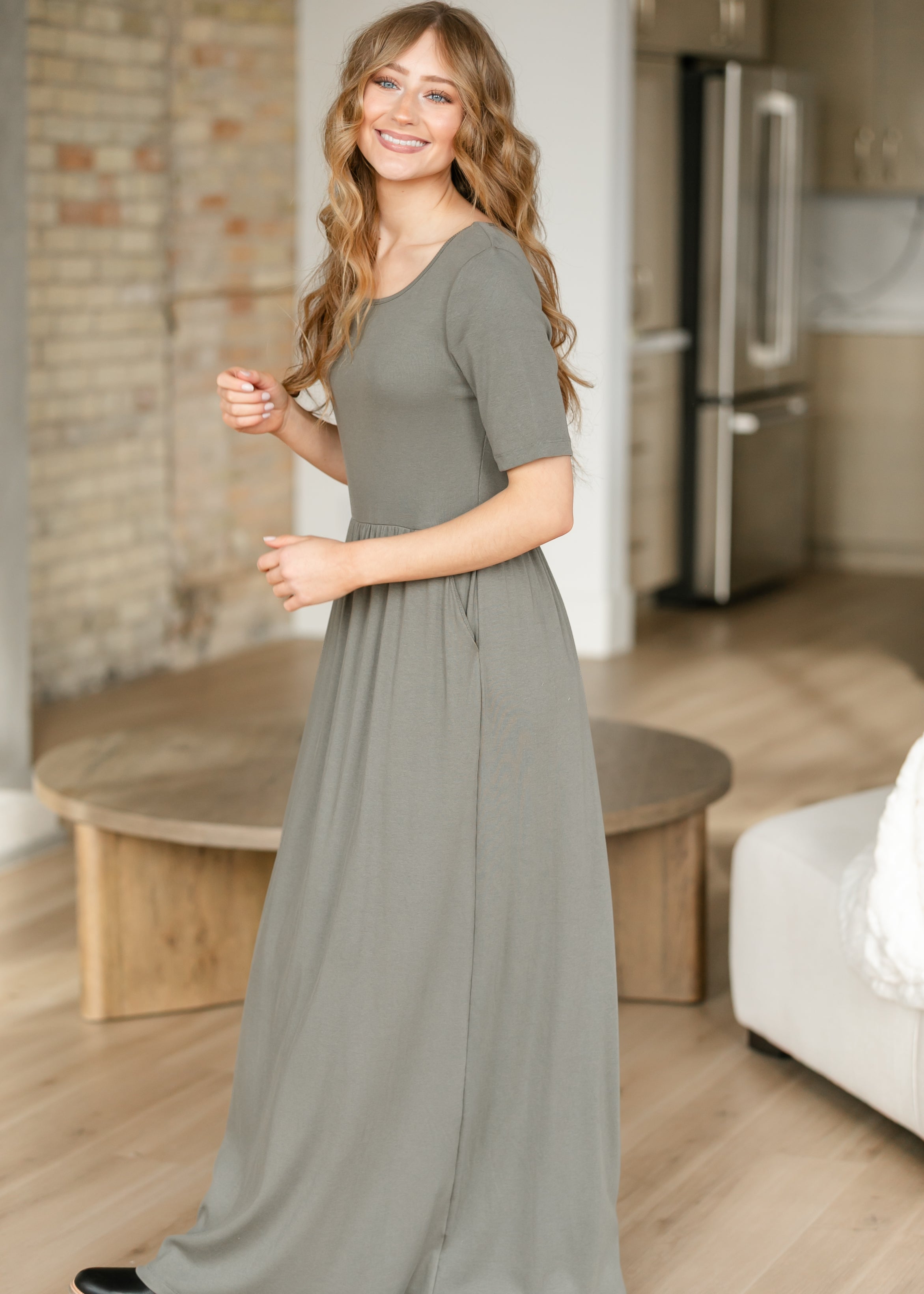 Close-up of the elegant neckline on the Inherit Co. Jasmine Olive Ribbed Maxi Dress, showing fine detail.