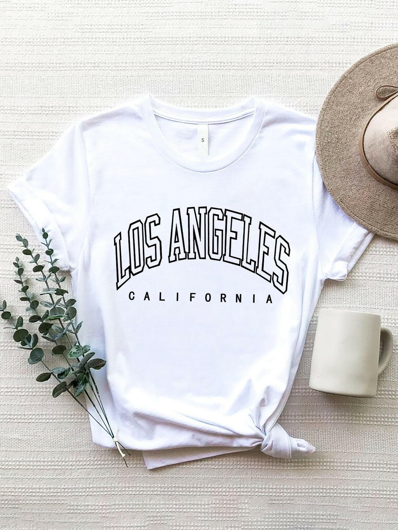 City of Angels California Round Neck TeeCity of Angels California Round Neck Tee
 Upgrade your style game with the City of Angels California Round Neck Tee, a perfect fusion of comfort and chic. This tee iLove Salve Angels California Round Neck TeeGraphic