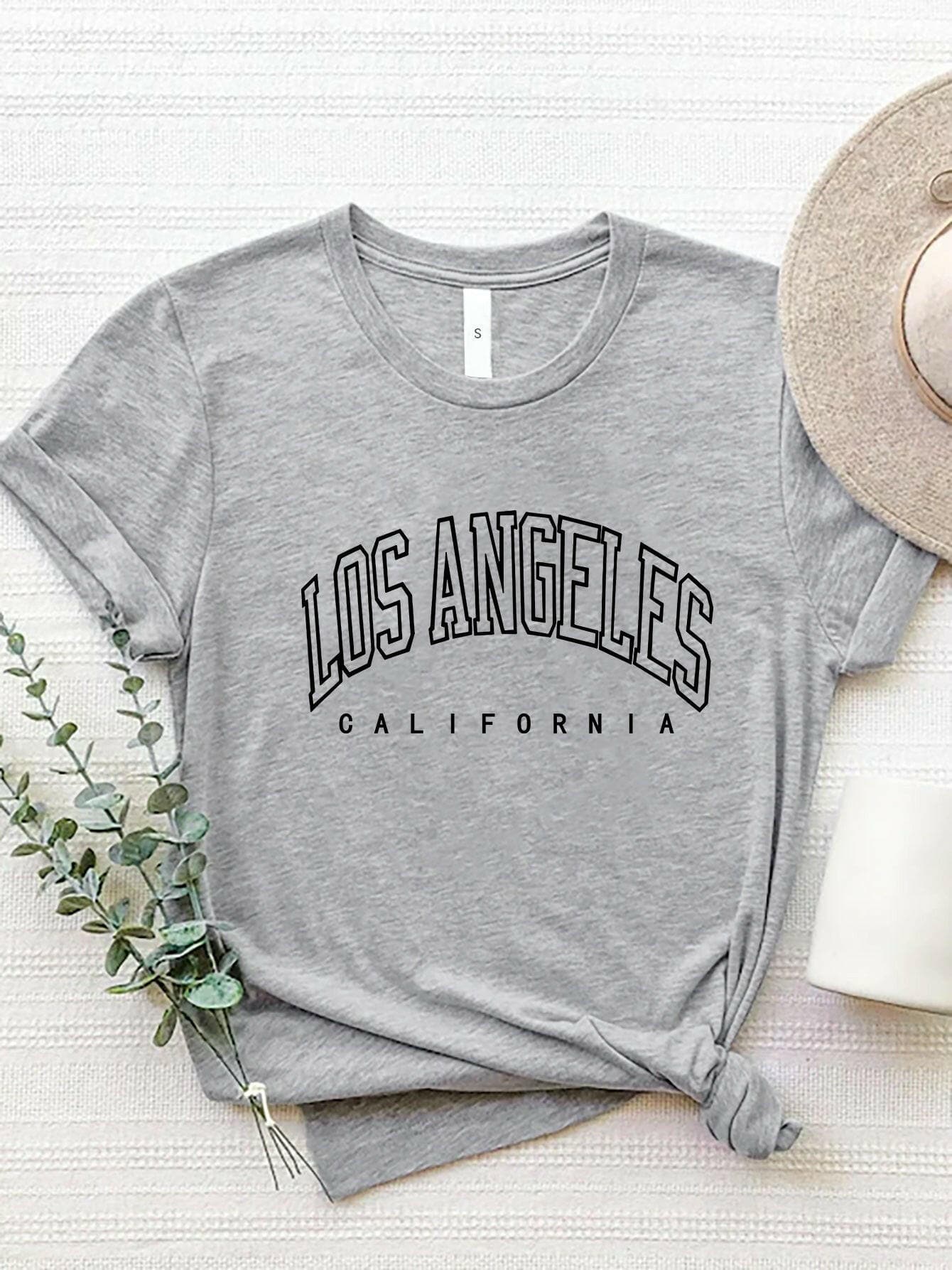 City of Angels California Round Neck TeeCity of Angels California Round Neck Tee
 Upgrade your style game with the City of Angels California Round Neck Tee, a perfect fusion of comfort and chic. This tee iLove Salve Angels California Round Neck TeeGraphic