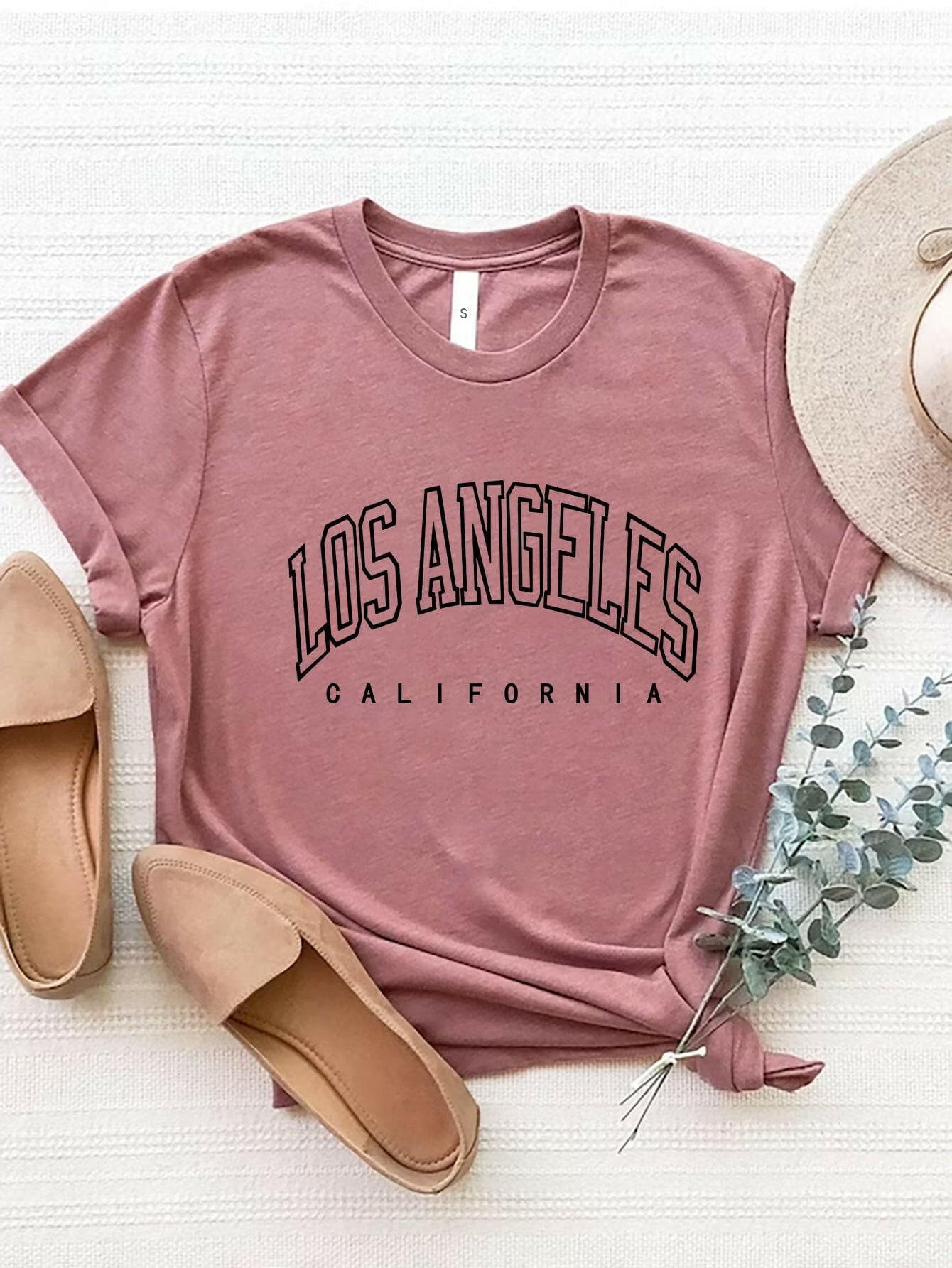 City of Angels California Round Neck TeeCity of Angels California Round Neck Tee
 Upgrade your style game with the City of Angels California Round Neck Tee, a perfect fusion of comfort and chic. This tee iLove Salve Angels California Round Neck TeeGraphic