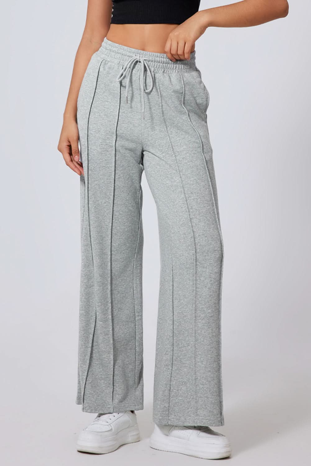 Gray high waist wide leg sweatpants with seamed detailing and drawstring.