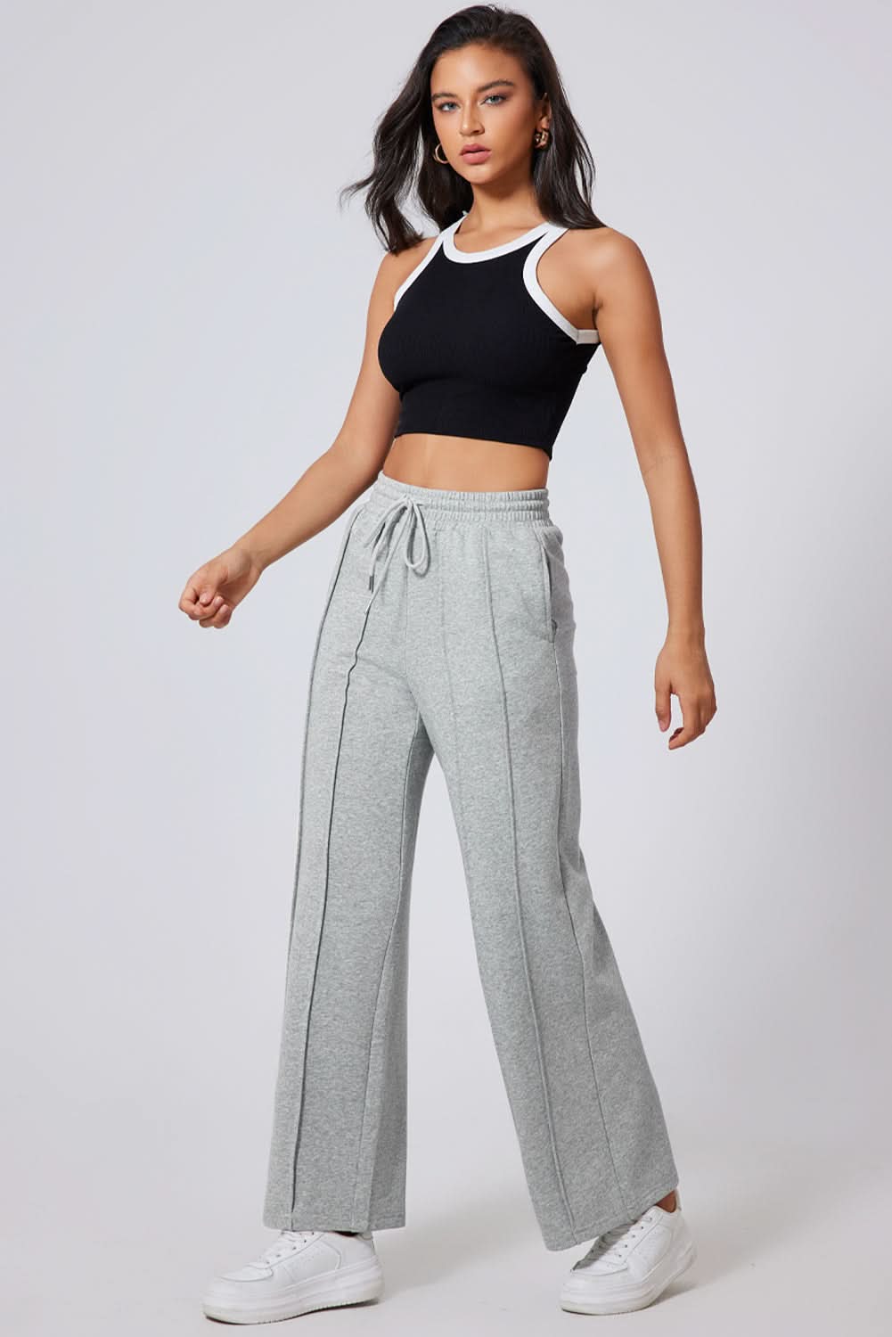 Chic gray wide leg sweatpants with seamed detailing and drawstring high waist.