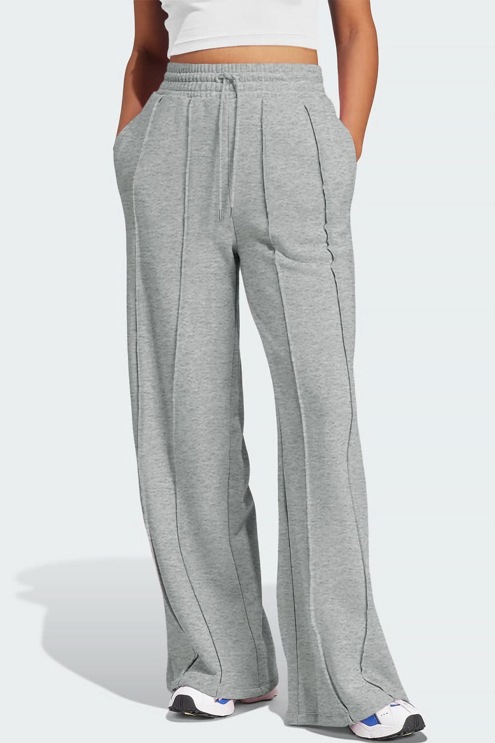 Chic gray wide leg sweatpants with seamed detailing and drawstring high waist.