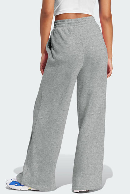 Gray wide leg sweatpants with high waist and drawstring.
