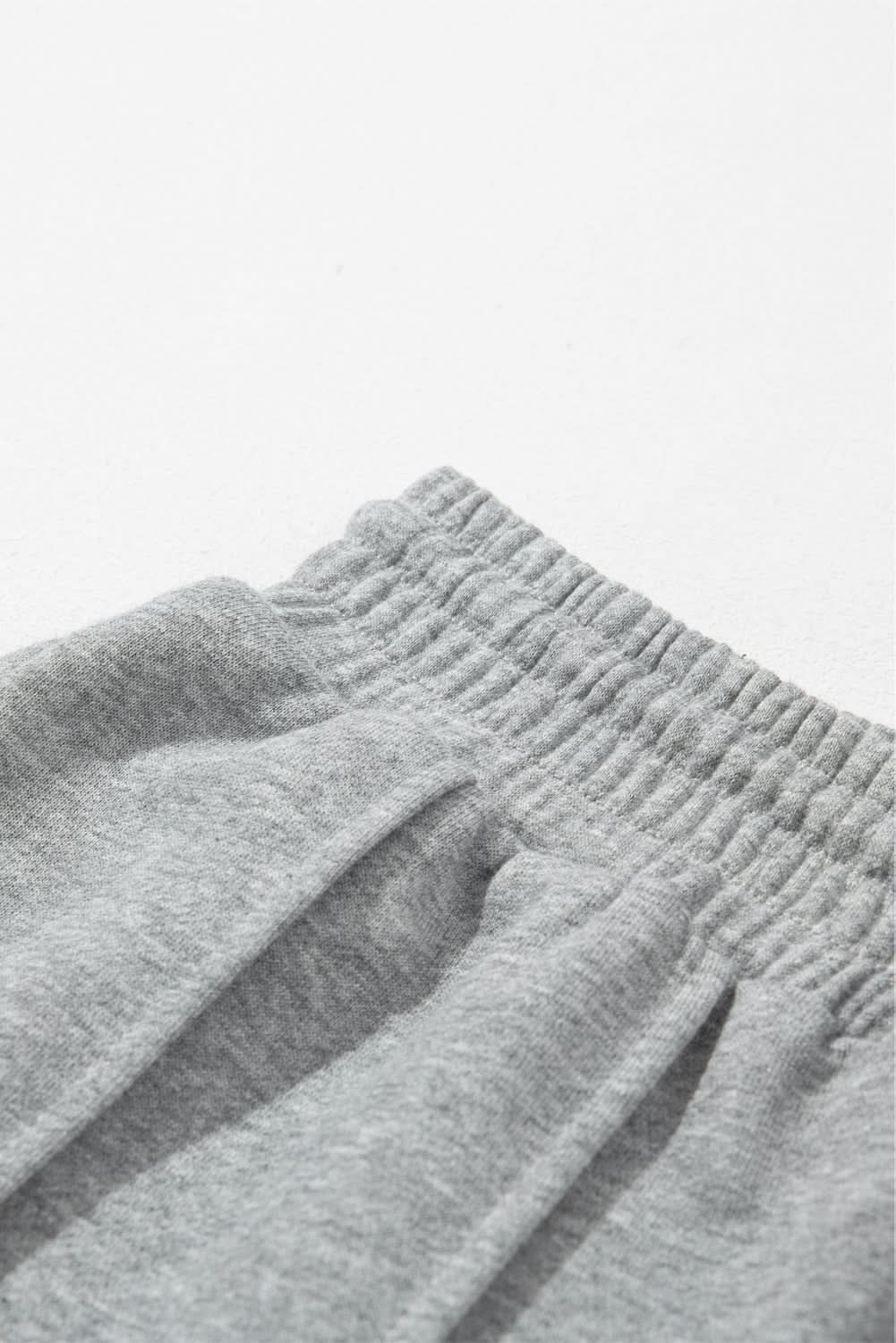Gray wide leg sweatpants with seamed detailing and drawstring high waist.