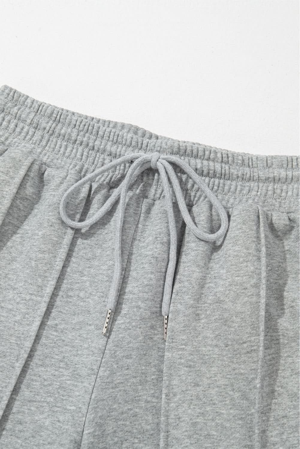 Gray wide leg sweatpants with drawstring and seamed detailing, high waist casual wear.