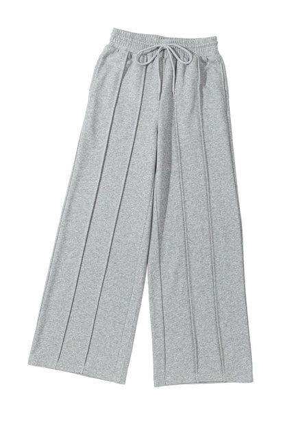 Gray wide leg sweatpants with seamed detailing and drawstring high waist.
