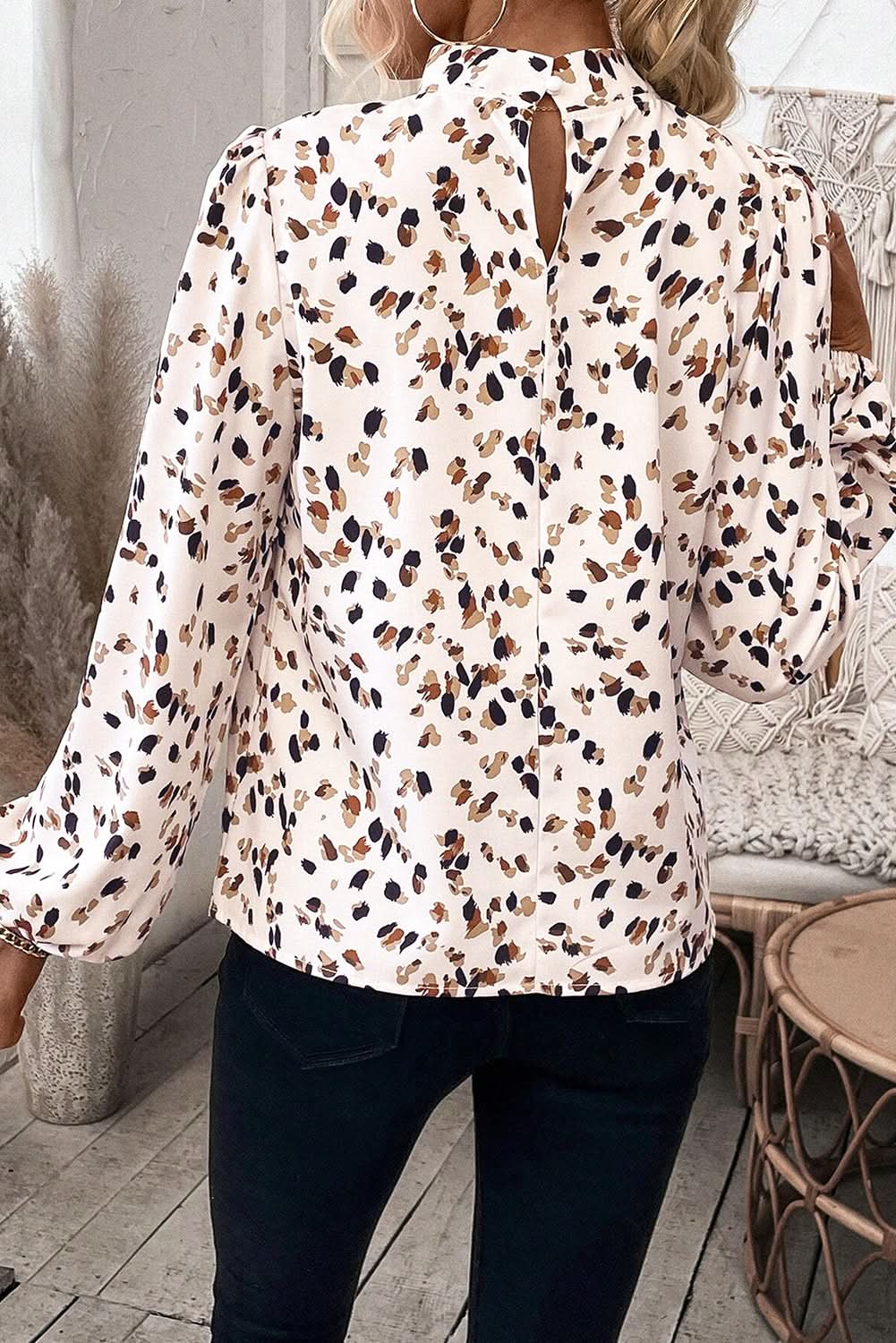 White leopard print lantern sleeve mock neck pleated blouse with flattering silhouette.