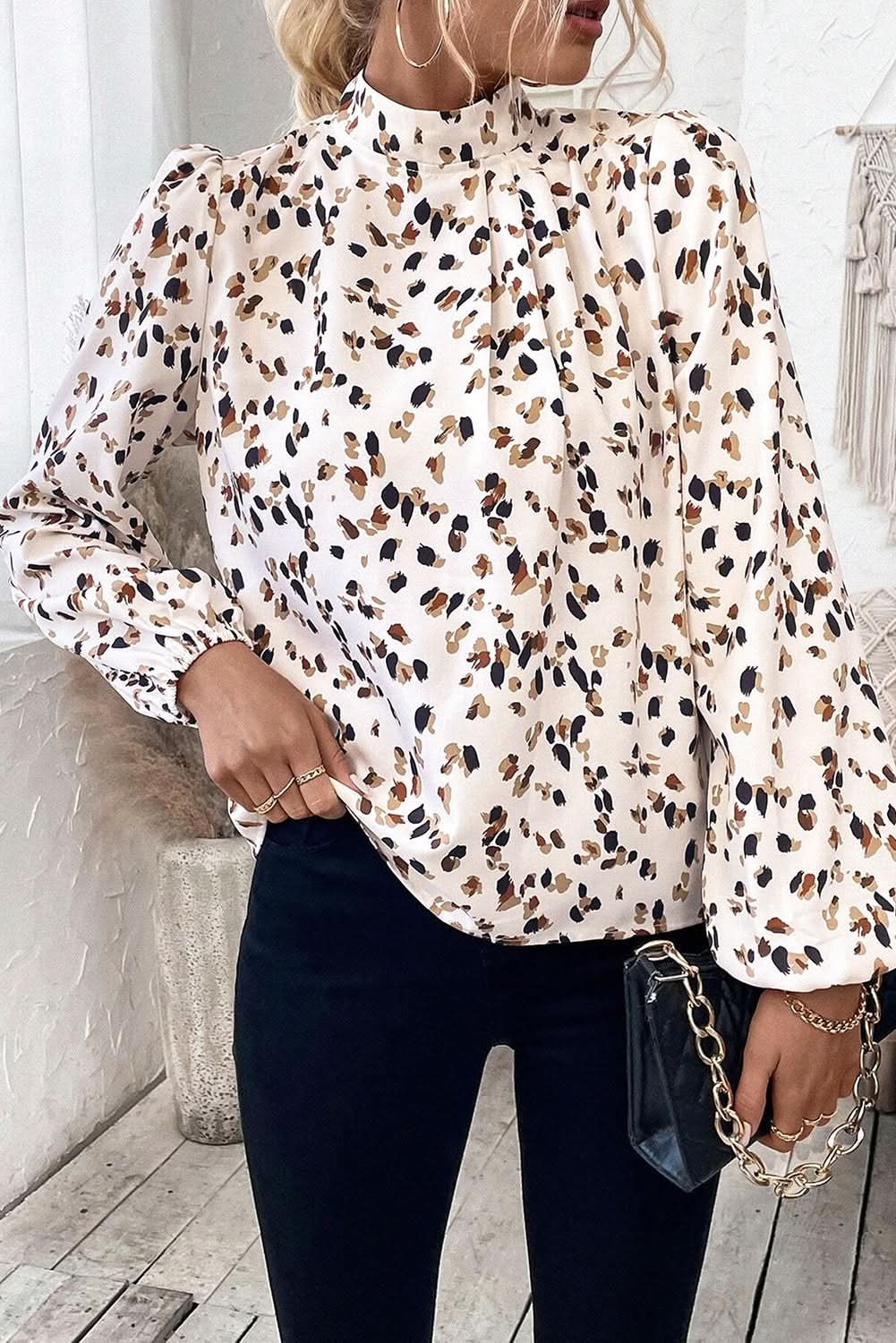 White leopard print lantern sleeve mock neck pleated blouse.