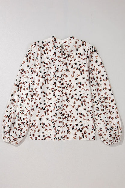 White leopard print lantern sleeve mock neck pleated blouse.