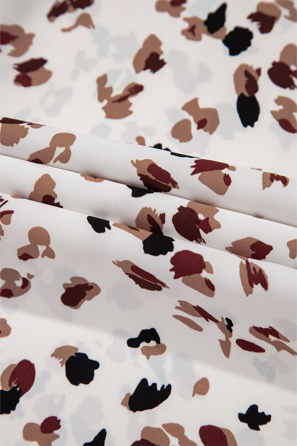 White Leopard Print Lantern Sleeve Mock Neck Pleated Blouse with chic design and flattering fit.