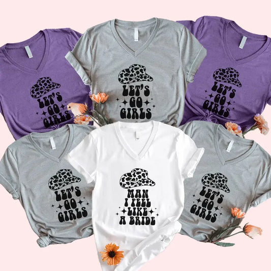Adorb.co Man I Feel Like a Bride bachelorette party matching V-neck t-shirts shown in white with elegant black script.
