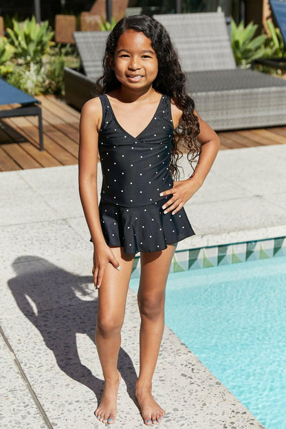 Elegant Black and White Polka Dot Swimsuit Dress by Marina West SwimExperience Timeless Elegance
 Unveil your charm this summer with the Elegant Black and White Polka Dot Swimsuit Dress by Marina West Swim. This exquisite swim dress Love Salve White Polka Dot Swimsuit Dressswimwear