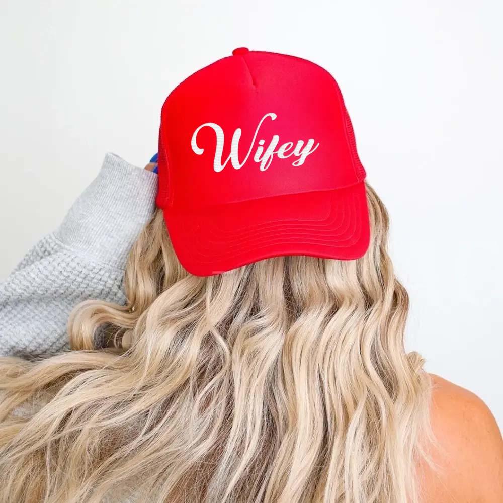 Side profile of the Adorb.co Wifey trucker hat, showing the structured white front panel and breathable black mesh.