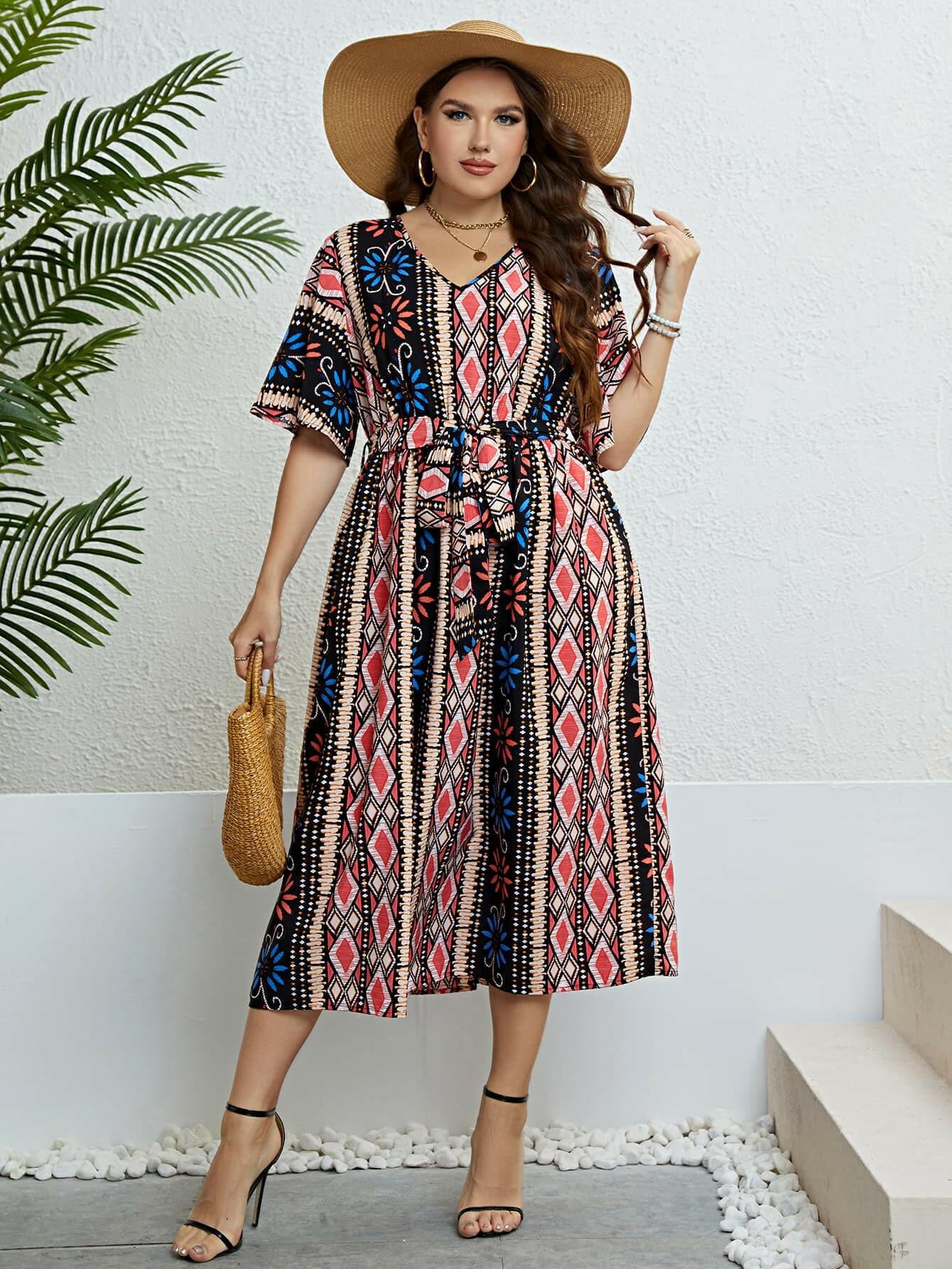 Boho V-neck midi dress with belt featuring a unique printed design and flattering V-neckline.