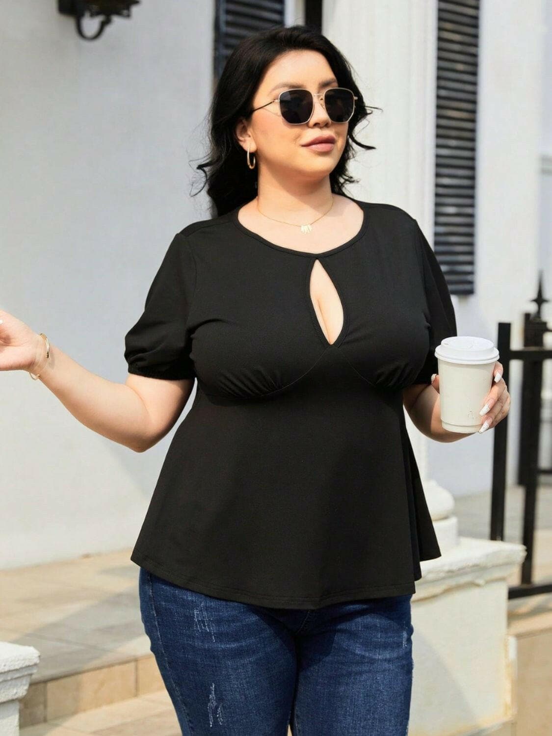 Curvy cutout short sleeve top with unique sheer design worn by a person holding a cup.