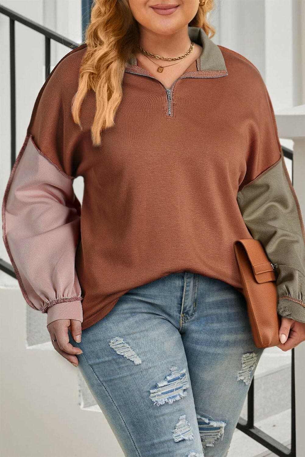 Chic plus size color block zip sweatshirt with exposed seams and comfort stretch fabric.