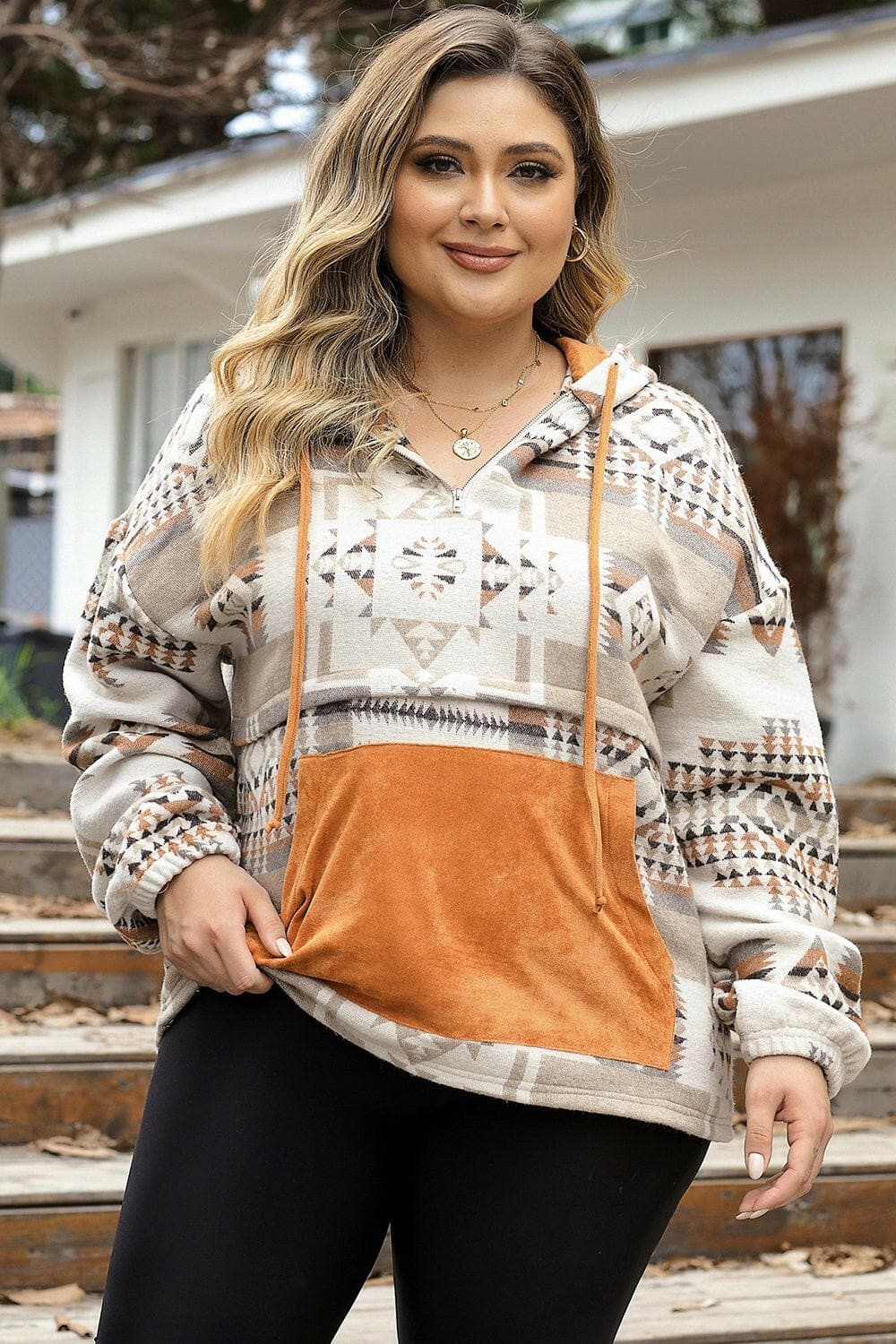 Plus size geometric print hoodie with adjustable drawstring and kangaroo pockets.