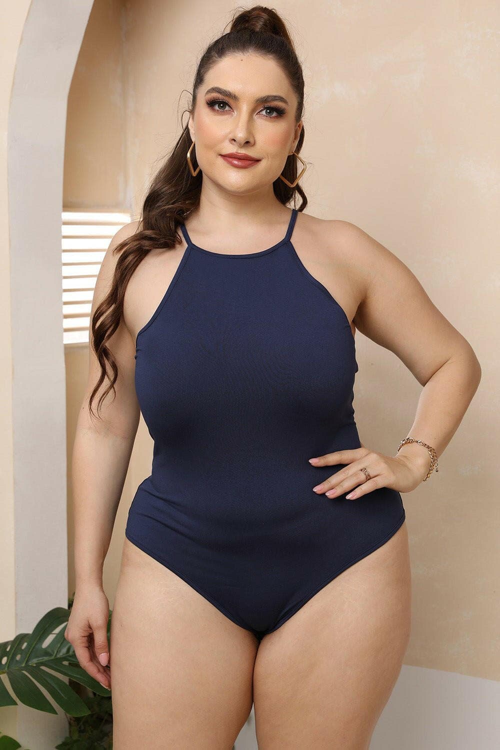 Curvy halter neck spaghetti strap bodysuit in navy blue showcasing a flattering and sophisticated design.