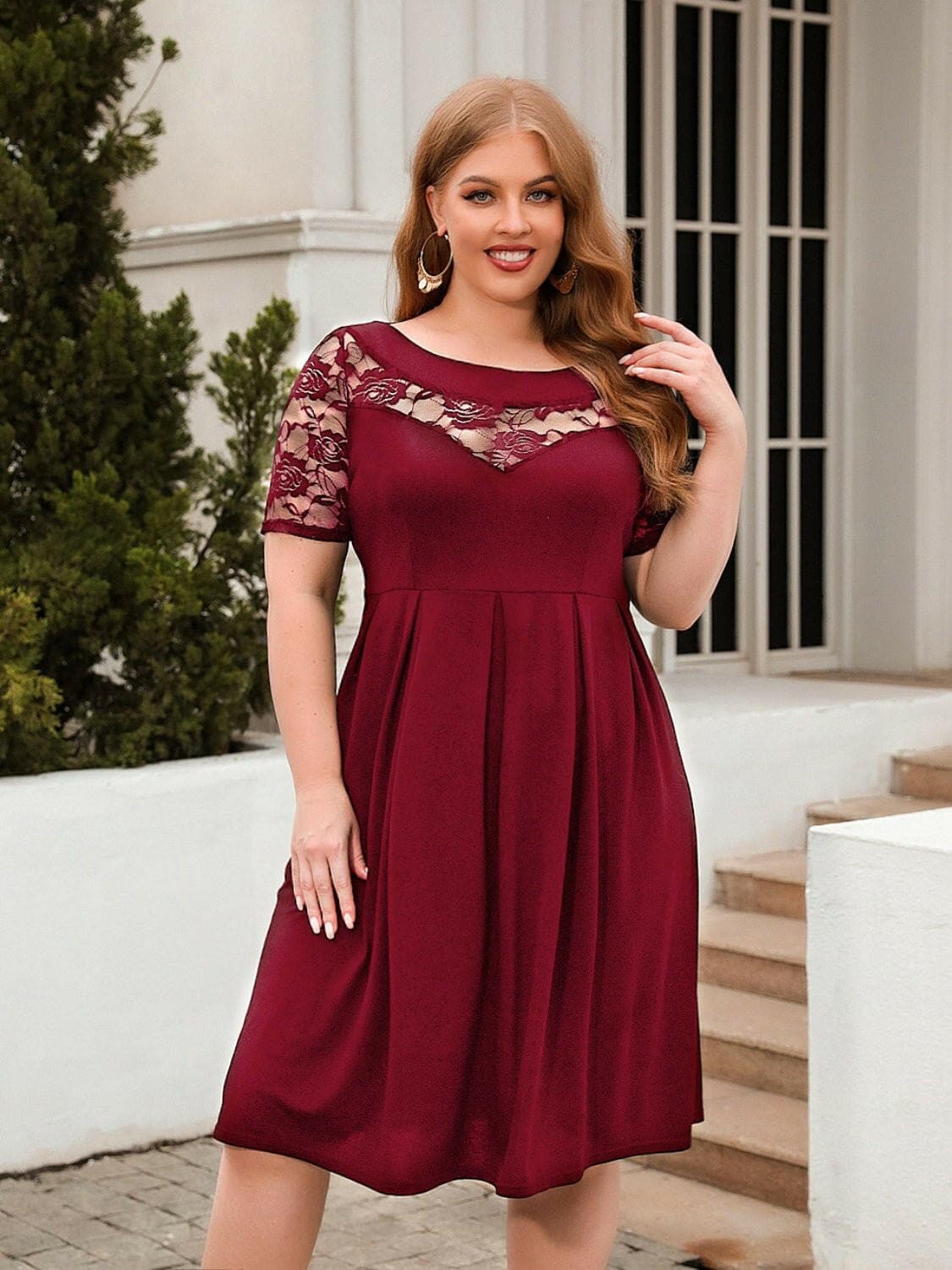 Elegant plus size lace dress with short sleeves and exquisite lace detailing.