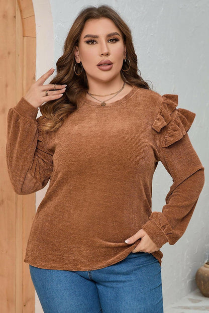 Plus size ruffled black blouse with long sleeves and elegant design.