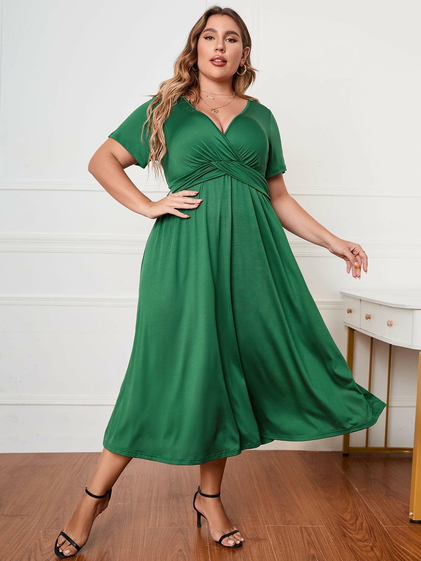 Plus size green surplice midi dress with short sleeves and A-line fit.