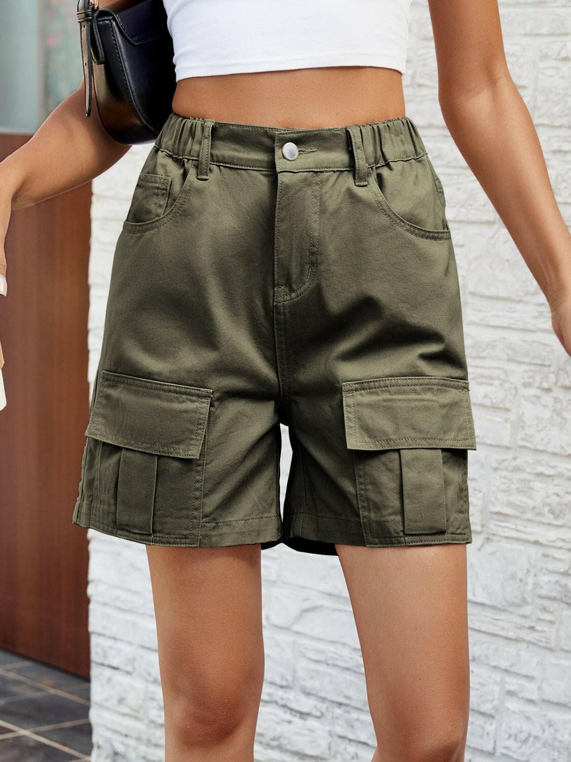 Chic high-waisted denim shorts with functional pockets and button closure.