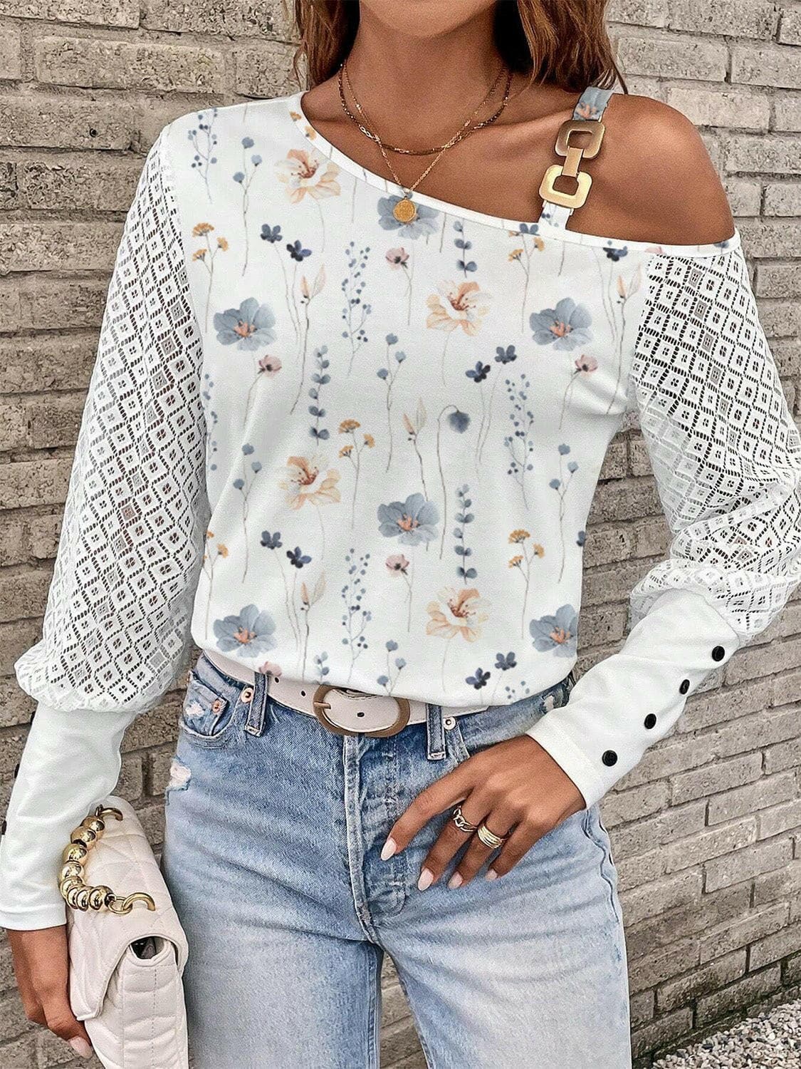 Chic asymmetrical sleeve t-shirt with unique neck detail and floral pattern.