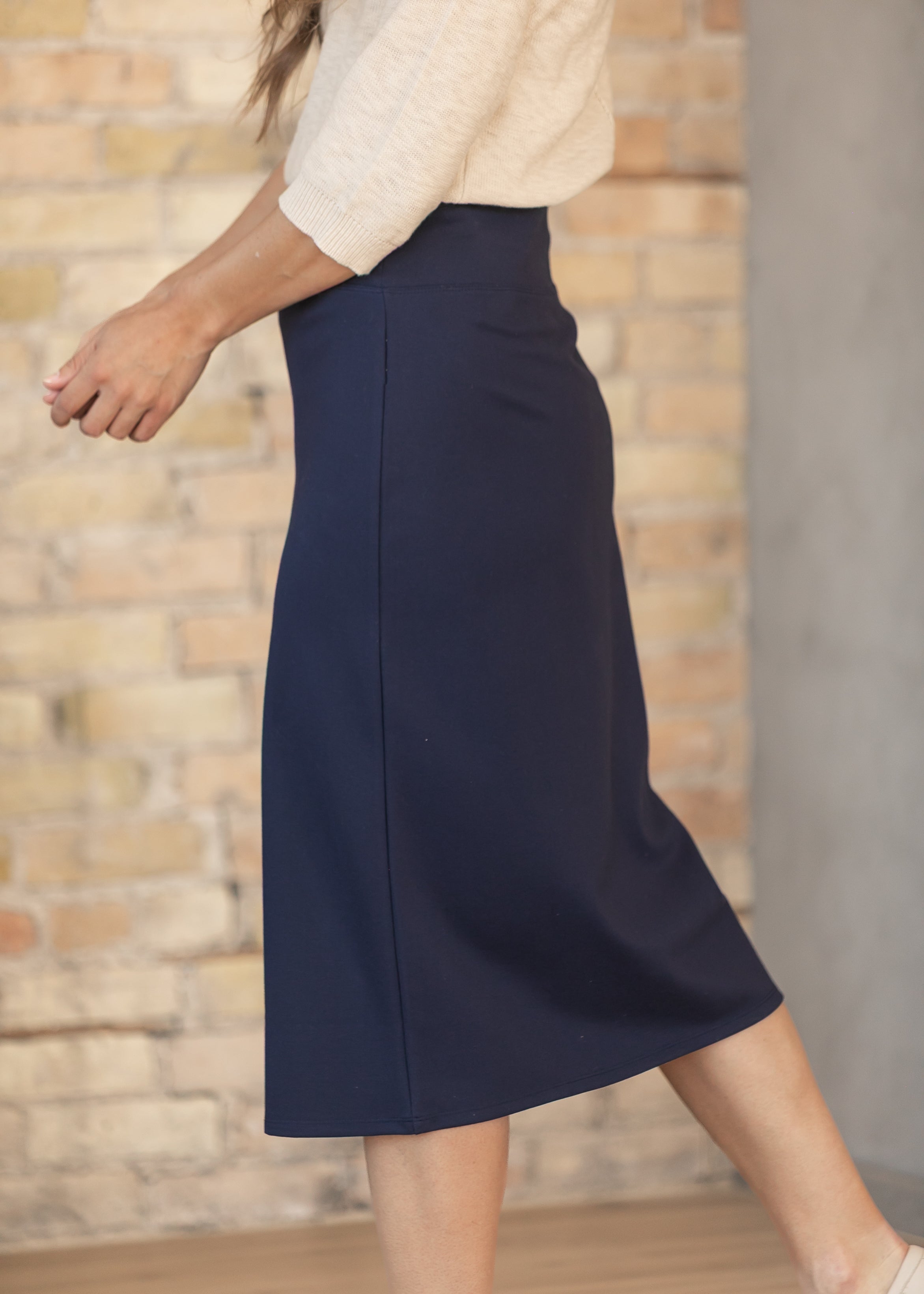 Inherit Co. Quinn Midi Skirt in a relaxed setting, highlighting its comfort and ease for quality everyday styling.