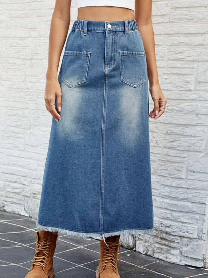 Chic denim skirt with pockets and raw hem, showcasing a buttoned design and vintage flair.