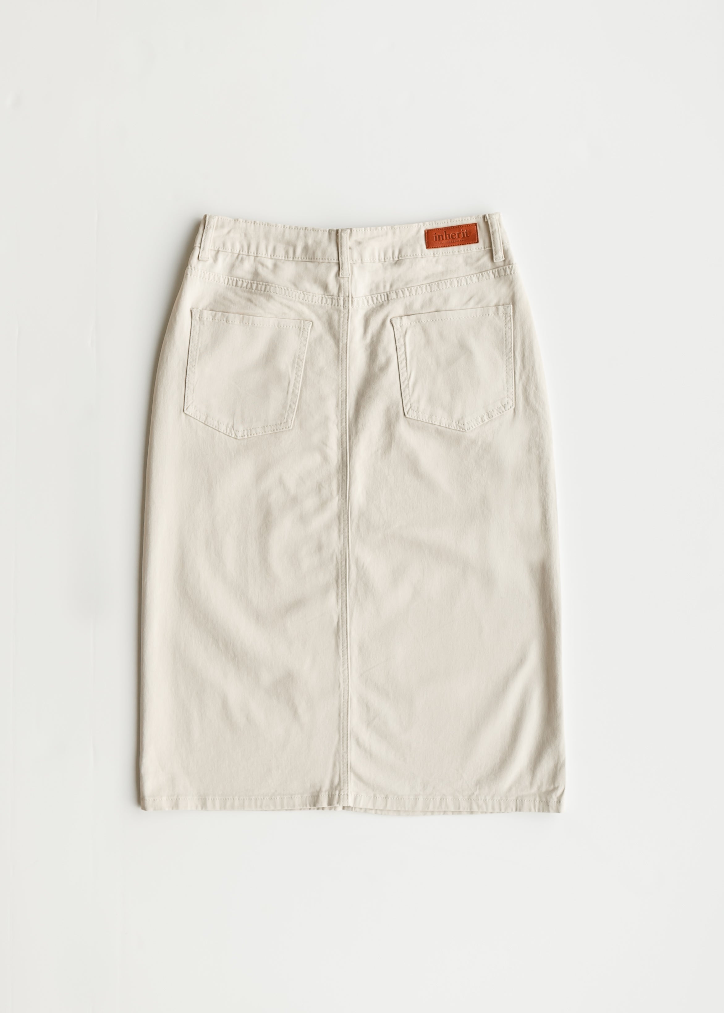 Close-up of Inherit Co. Remi Cloud Denim Midi Skirt, highlighting soft cloud wash denim texture.