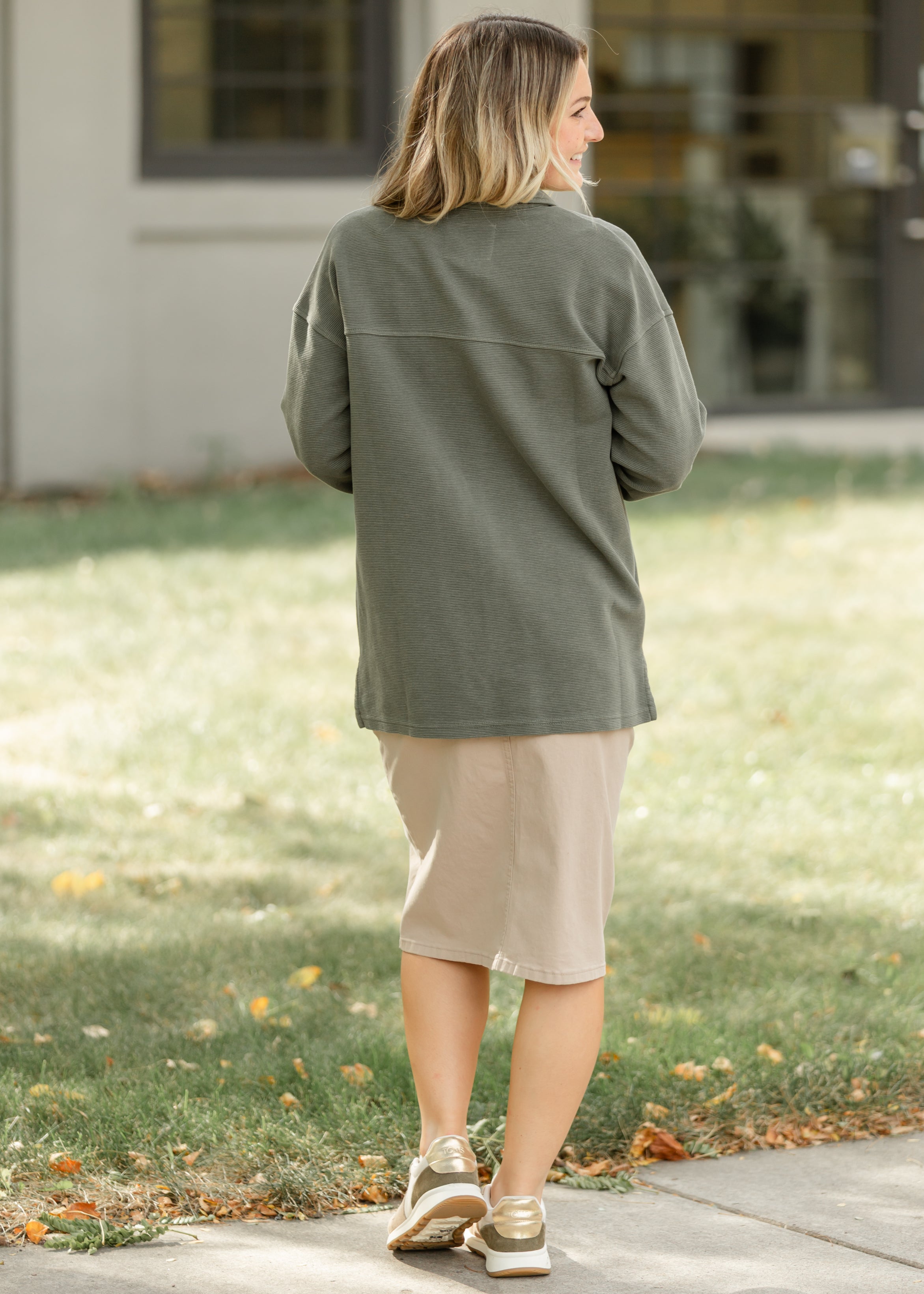 Bottom hem detail of the Inherit Co. Remi Simply Taupe Denim Midi Skirt, emphasizing its modest length and durable finish.
