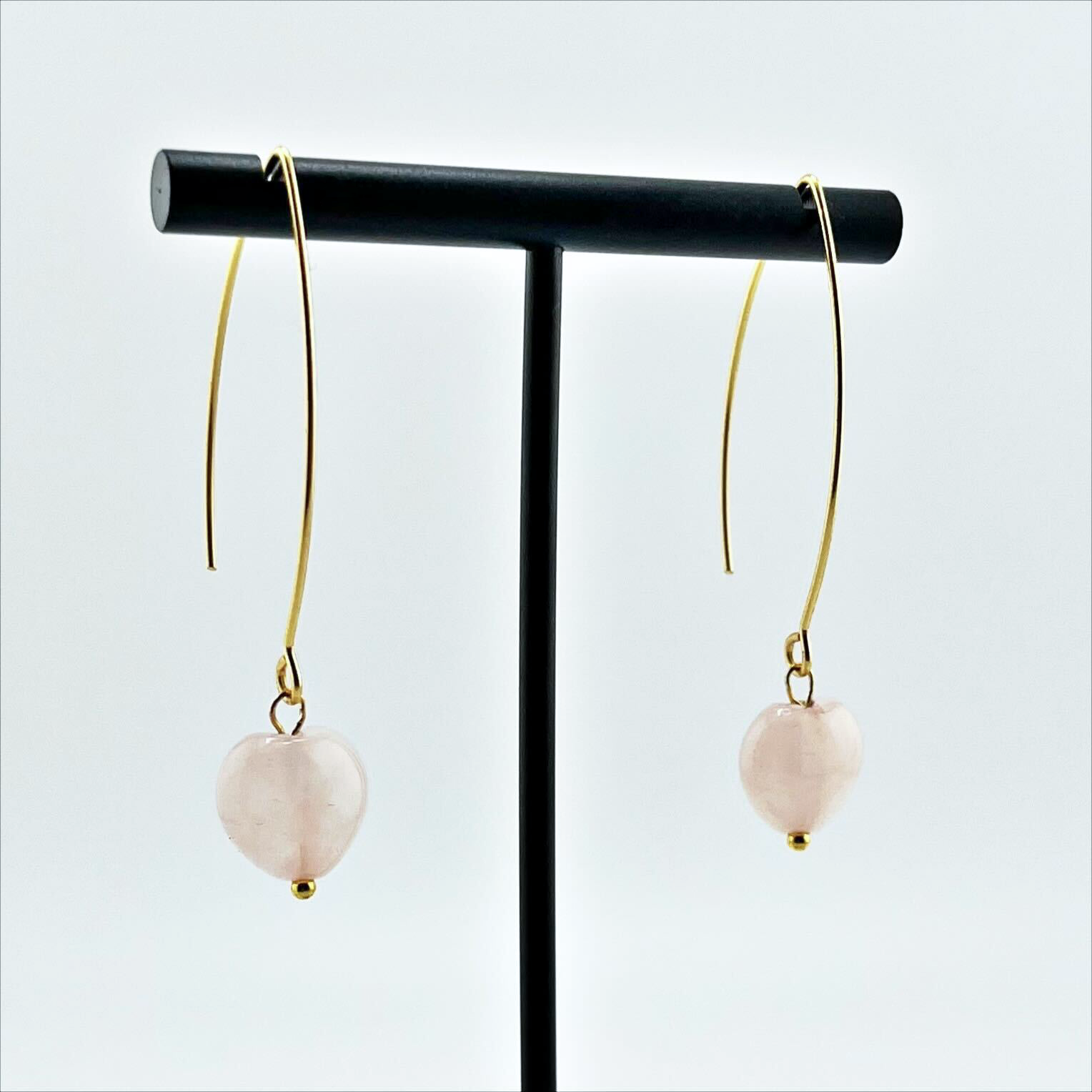 Side view of Katia Designs Small Stone Drop Earrings, highlighting the polished light blue stone's smooth finish and secure gold-plated hook.