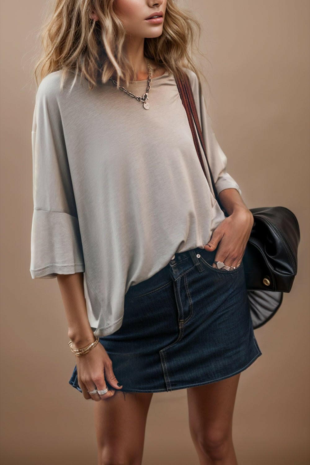 Three-quarter sleeve round neck tee with denim skirt, effortless style.