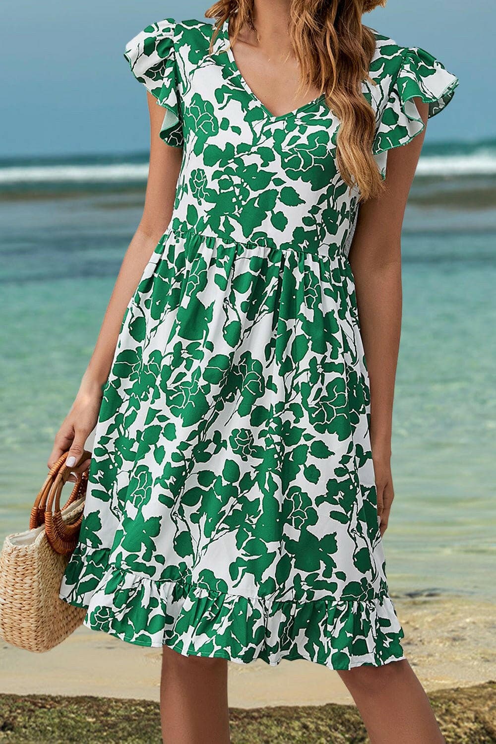 Floral ruffle cap sleeve dress with V-neck and green floral print.