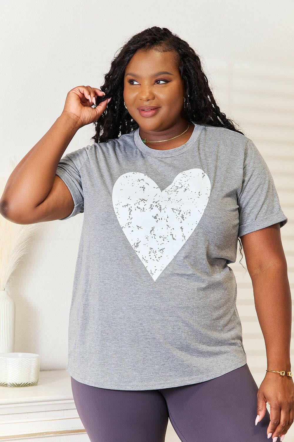 Heartfelt Charm Short Sleeve Tee with rolled sleeves and heart graphic design.