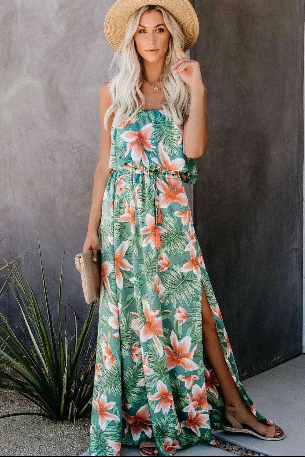 Tropical slit sleeveless maxi dress with floral print and elegant design.