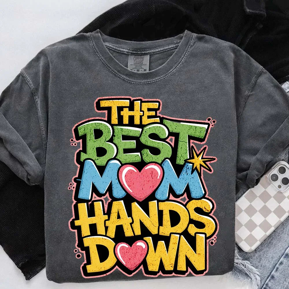 Adorb.co Mom Hands Down graphic tee paired with a coffee mug, perfect for a relaxed morning. A cute and comfortable Mom T-shi