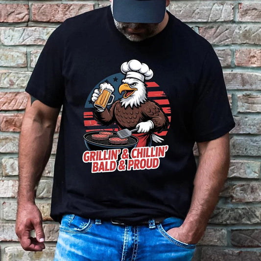 Adorb.co Grillin’ & Chillin’ patriotic bald eagle BBQ vintage tee. The men's graphic tee is shown in black on a model.