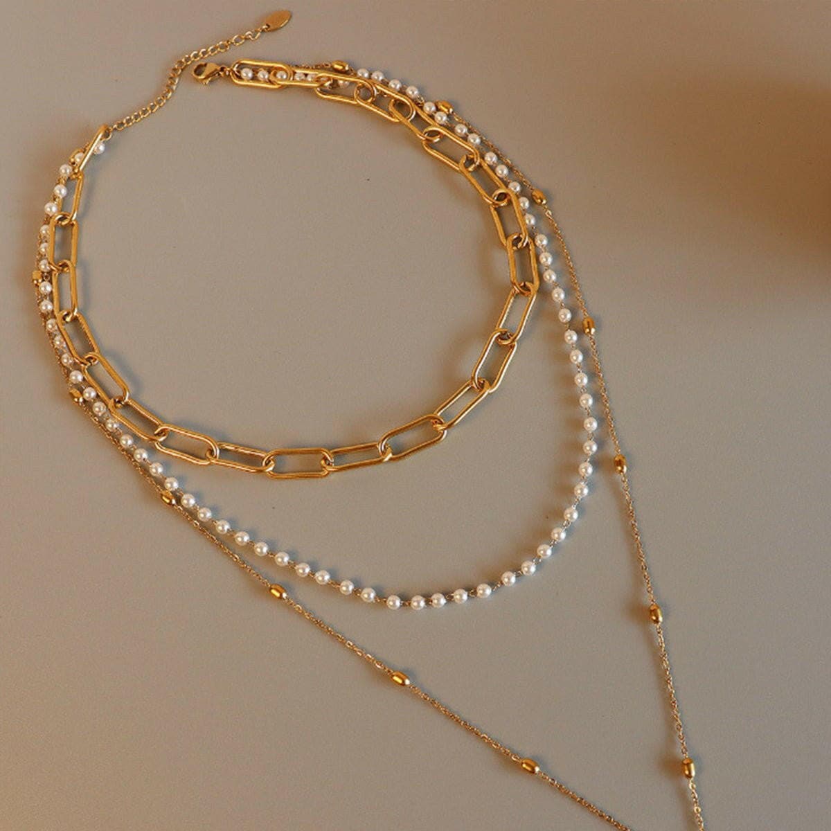 Three-Layered Synthetic Pearl Necklace with Titanium Steel ChainThree-Layered Synthetic Pearl Necklace with Titanium Steel Chain
 Indulge in sophistication and elevate your style with our Three-Layered Synthetic Pearl Necklace. TLove Salve -Layered Synthetic Pearl Necklacejust arrived