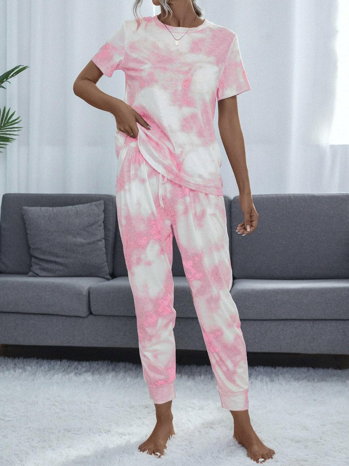 Groovy Tie-Dye Matching Set in vibrant pink and white pattern on a woman, showcasing a stylish and comfortable lounge set.