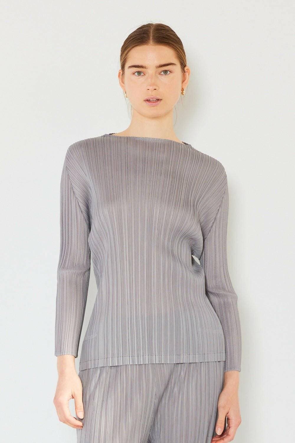 Sophisticated pleated top with boatneck style, long sleeves, and flattering design.