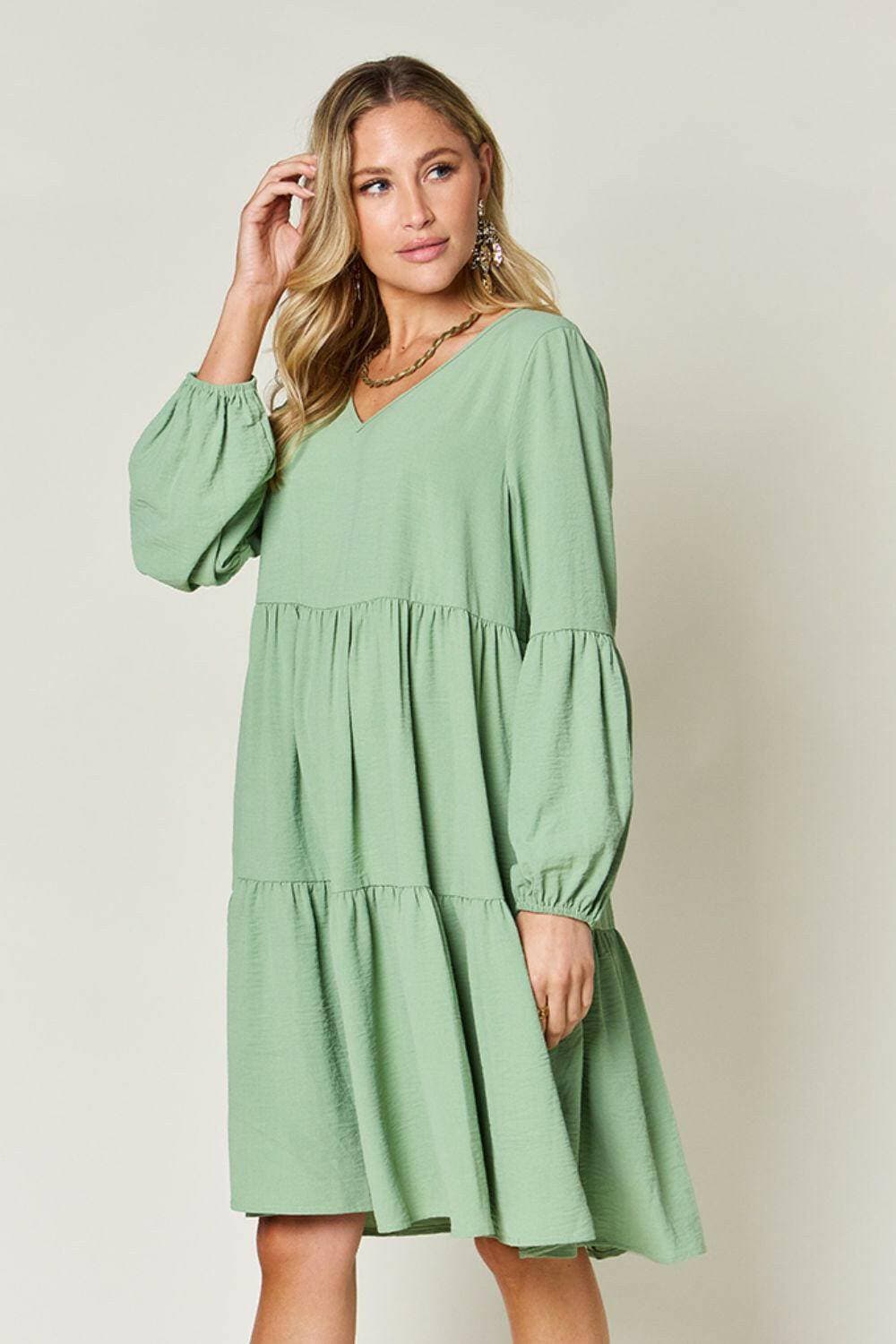 Double Vision V-Neck Balloon Sleeve Tiered DressDouble Vision V-Neck Balloon Sleeve Tiered Dress
 Step into the spotlight with our Double Vision V-Neck Balloon Sleeve Tiered Dress, a masterpiece designed to turn hLove Salve -Neck Balloon Sleeve Tiered DressColor