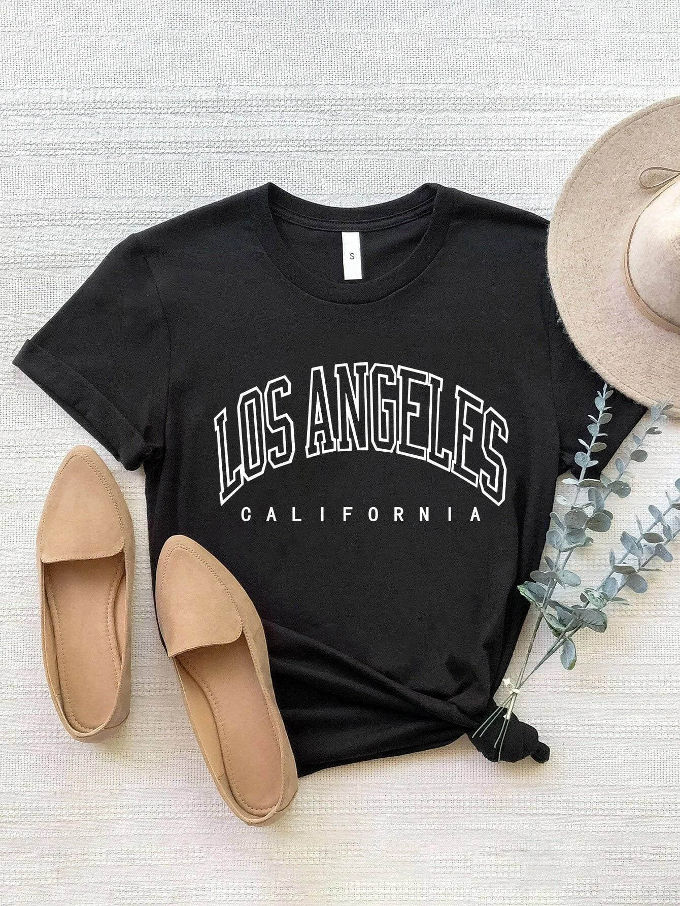 City of Angels California Round Neck TeeCity of Angels California Round Neck Tee
 Upgrade your style game with the City of Angels California Round Neck Tee, a perfect fusion of comfort and chic. This tee iLove Salve Angels California Round Neck TeeGraphic