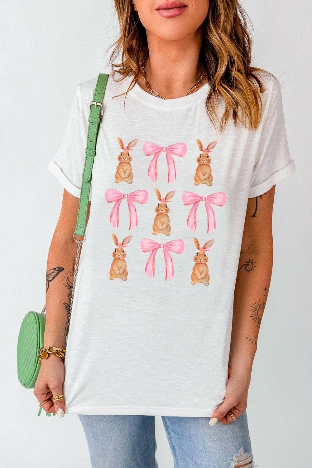 Whimsical Bunny & Bow Short Sleeve TeeWhimsical Bunny &amp; Bow Short Sleeve Tee
 Upgrade your style with the Whimsical Bunny &amp; Bow Short Sleeve Tee. Indulge in charm and comfort with our Rabbit &ampLove Salve Whimsical Bunny & Bow Short Sleeve TeeGraphic