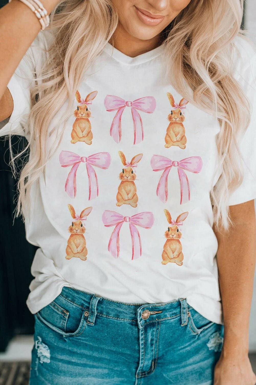 Whimsical Bunny & Bow Short Sleeve TeeWhimsical Bunny &amp; Bow Short Sleeve Tee
 Upgrade your style with the Whimsical Bunny &amp; Bow Short Sleeve Tee. Indulge in charm and comfort with our Rabbit &ampLove Salve Whimsical Bunny & Bow Short Sleeve TeeGraphic