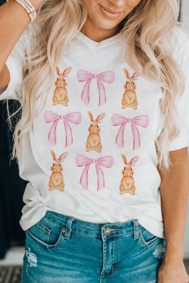 Whimsical Bunny & Bow Short Sleeve TeeWhimsical Bunny &amp; Bow Short Sleeve Tee
 Upgrade your style with the Whimsical Bunny &amp; Bow Short Sleeve Tee. Indulge in charm and comfort with our Rabbit &ampLove Salve Whimsical Bunny & Bow Short Sleeve TeeGraphic