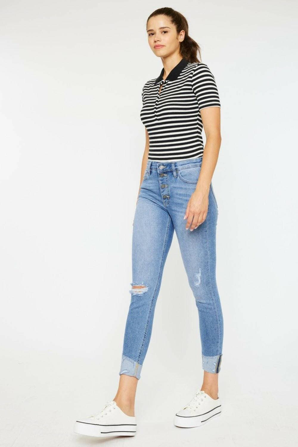 Trendy distressed denim jeans with retro button fly